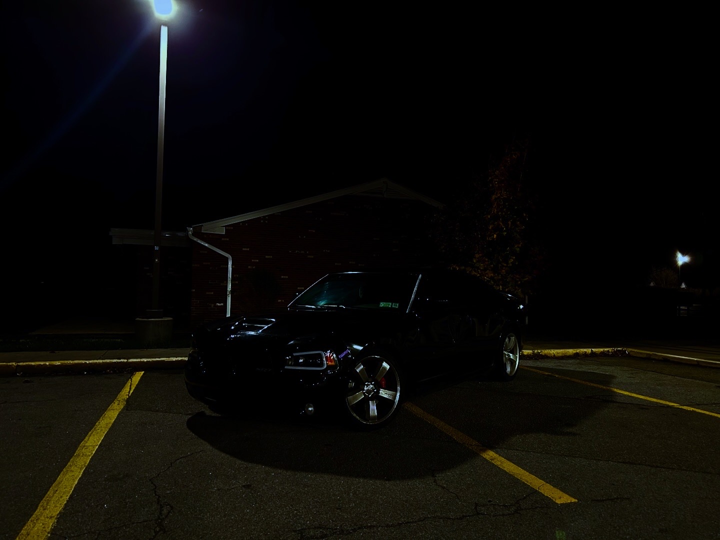 Wide environmental shot of a black performance sedan