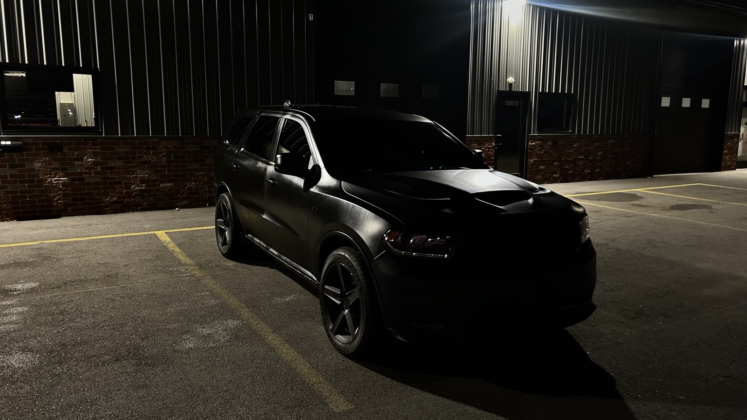 Black Durango under industrial lights at night
