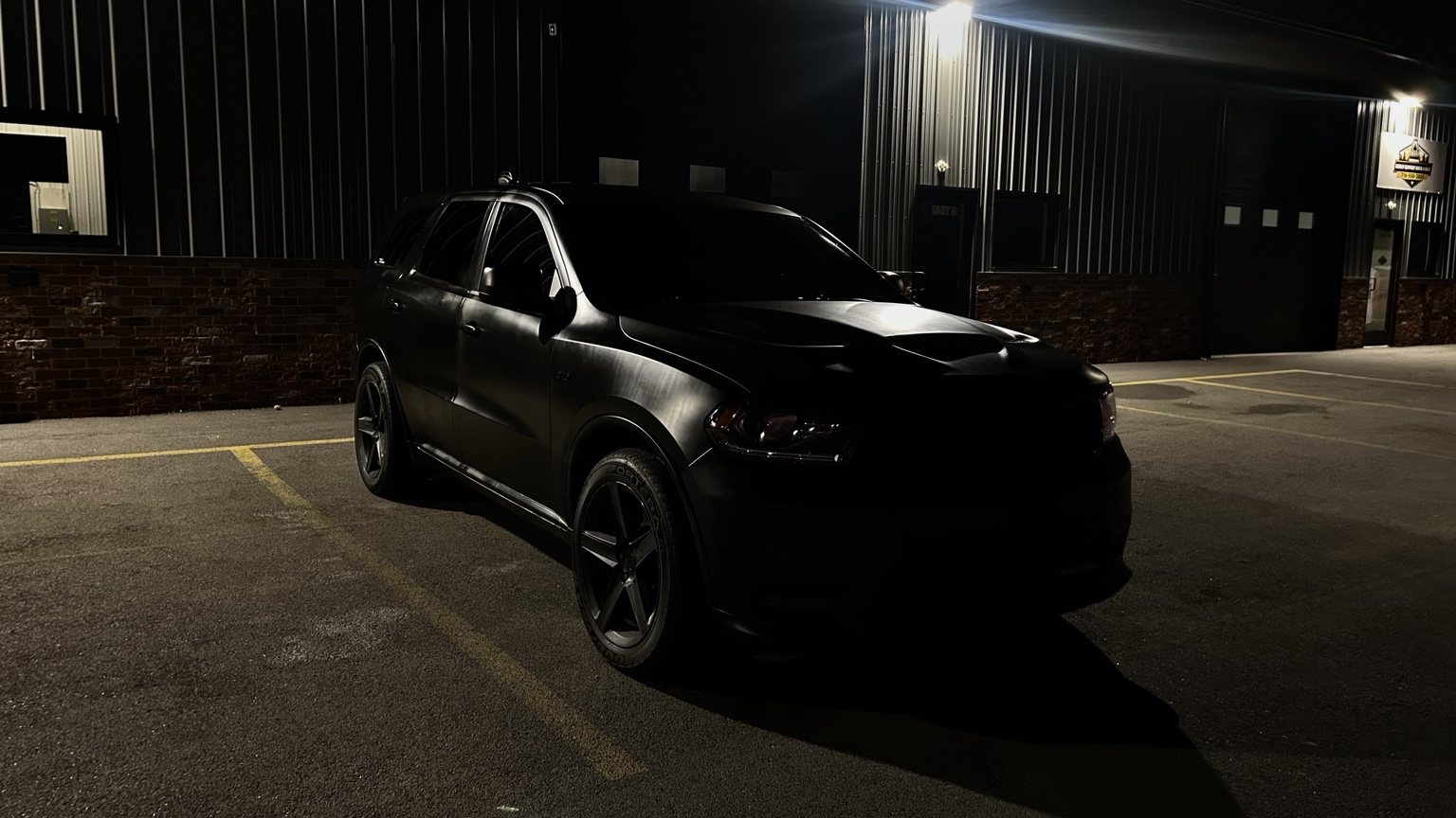 Black Durango parked beneath industrial lighting